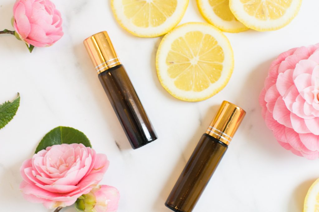 flowers and lemons with essential oil roller bottle