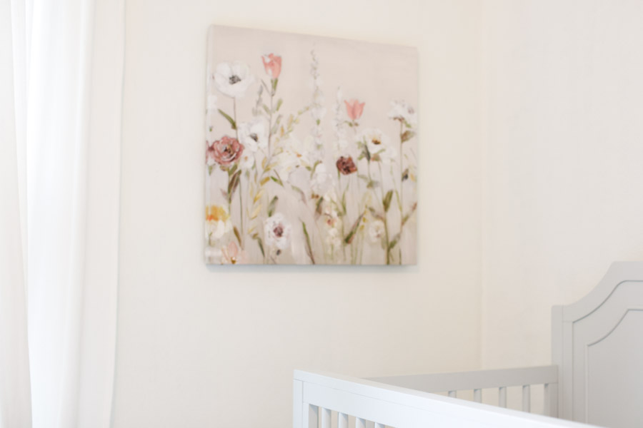 A thoughtfully chosen floral art piece used to decorate a home that uses cozy minimalism design.