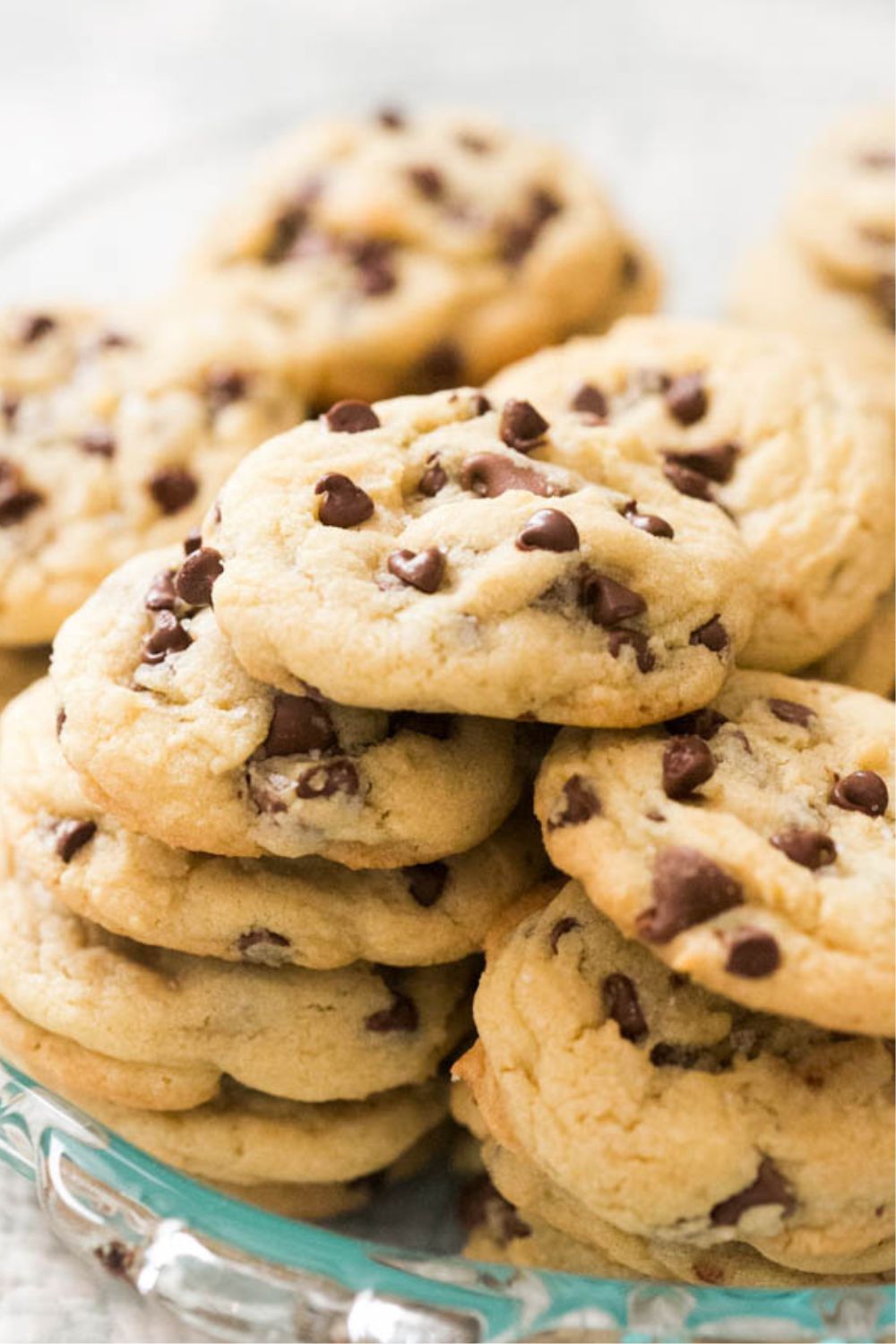 soft and chewy chocolate chip cookies stacked on a plate