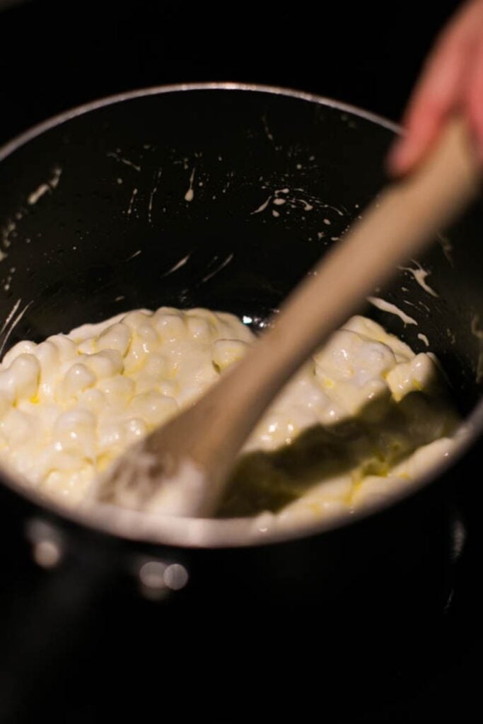 Butter and marshmallows melting in a pot for popcorn balls.