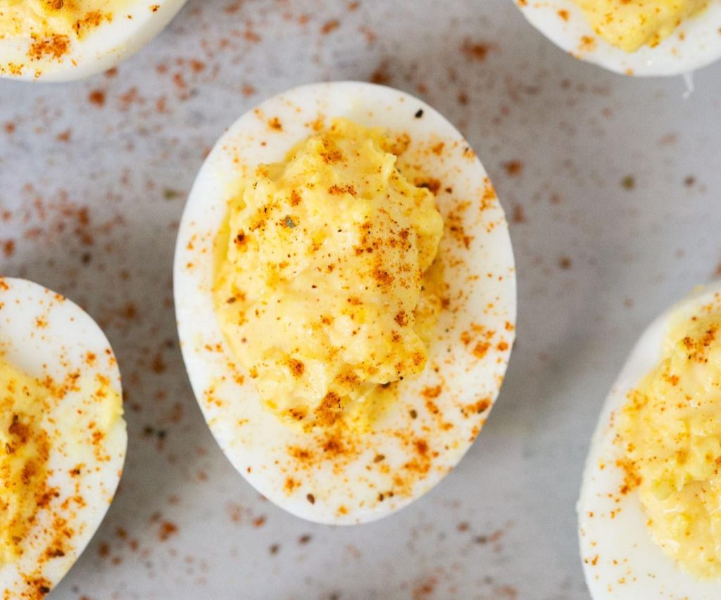 classic deviled egg made with mayo, mustard, black pepper, salt and paprika