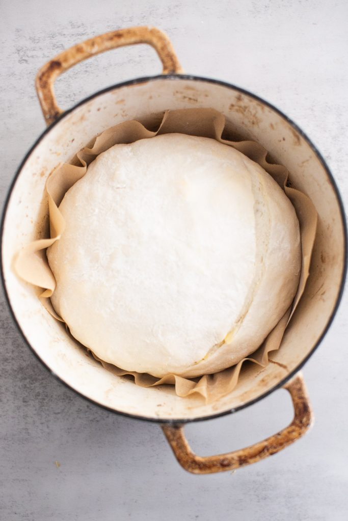 sourdough croissant bread shaped and placed in a dutch oven 