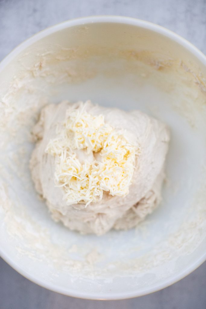 butter being added to sourdough croissant bread