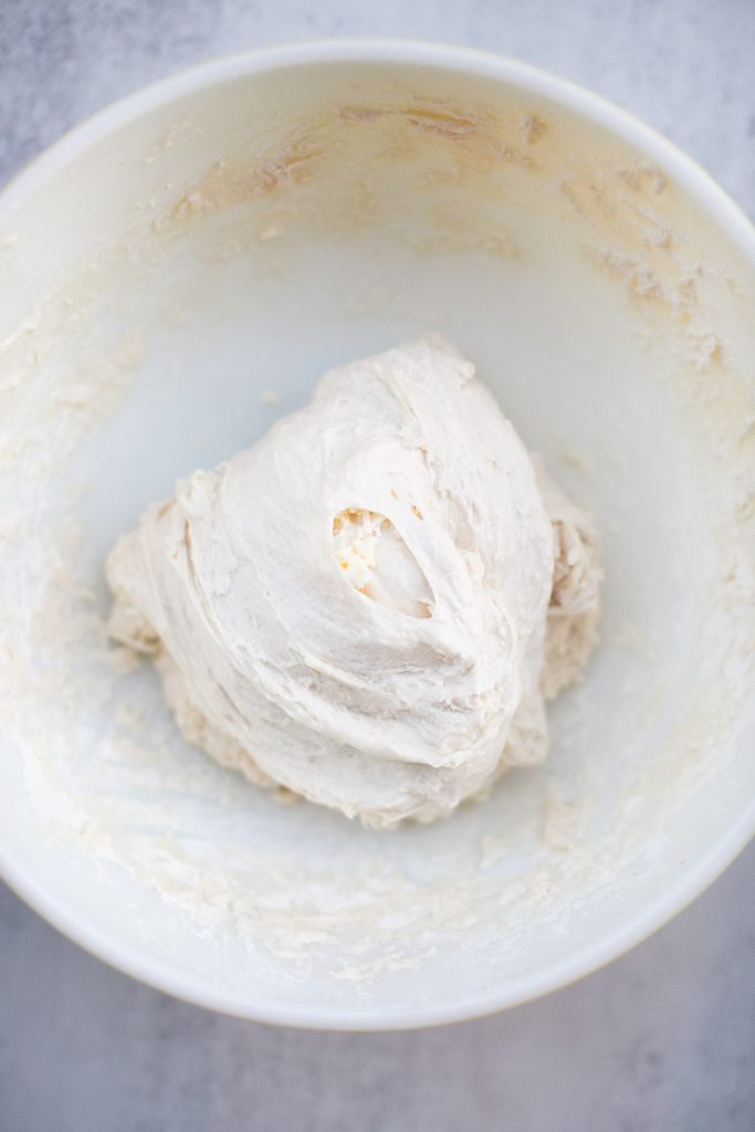 butter being added to sourdough croissant bread during stretch and folds