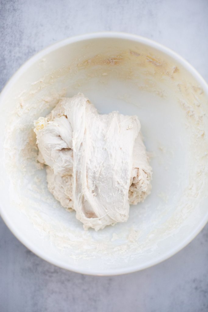 butter being added to sourdough croissant bread during stretch and folds