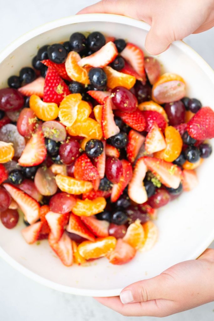 honey fruit salad with added limes and mandarin oranges.