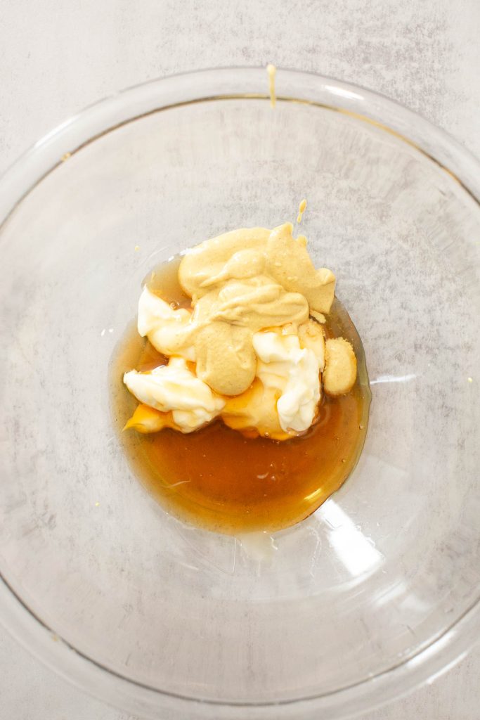honey, mayo and dijon mustard being mixed in a small bowl