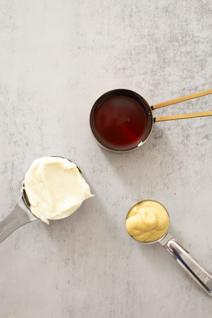 ingredients for honey mustard on a plate: 1/4 cup honey, 1/4 cup mayo, 2 tablespoons dijon mustard