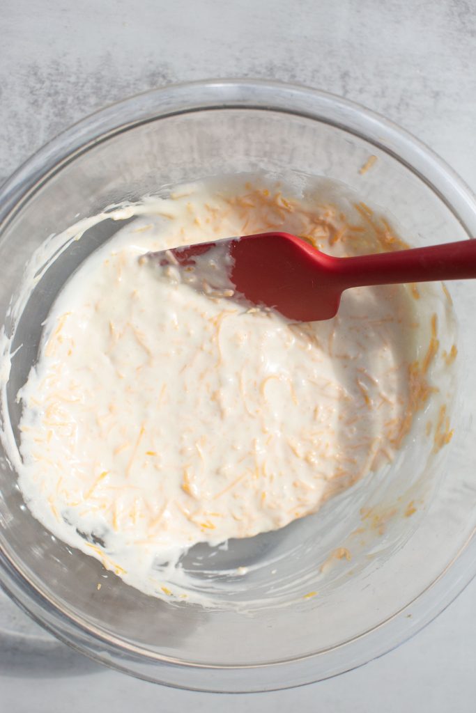 ingredients for sourdough cheese crackers mixed together in a bowl