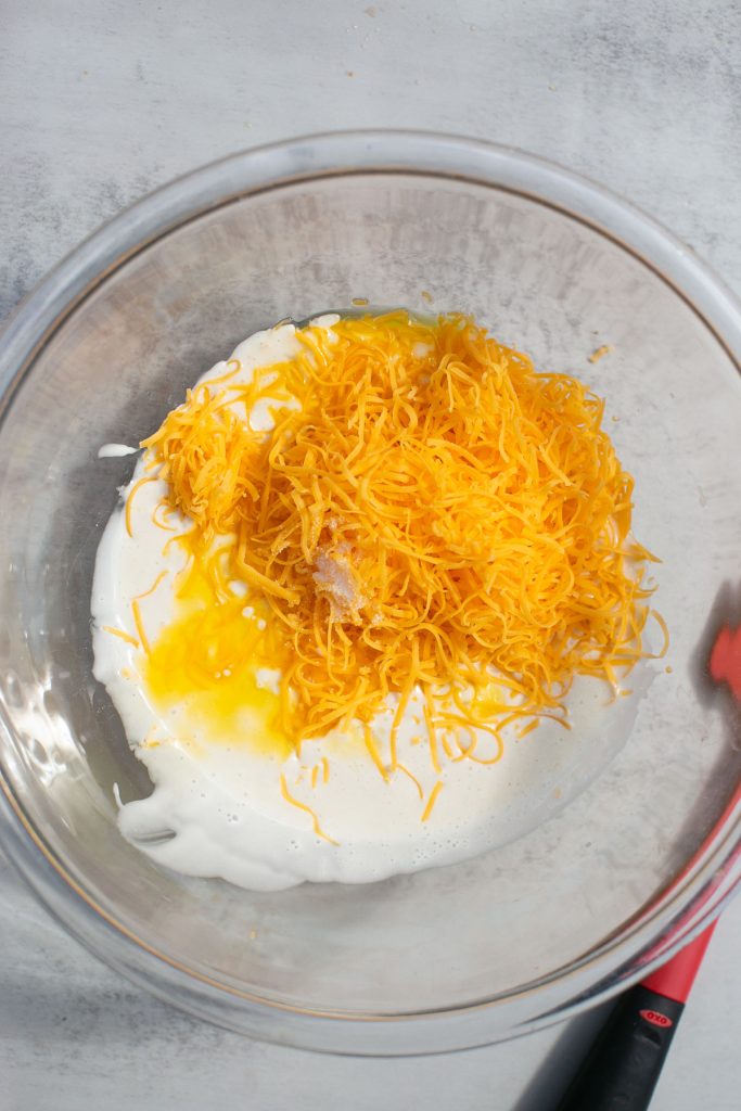 ingredients for sourdough cheese crackers: sourdough discard, melted butter, and cheese