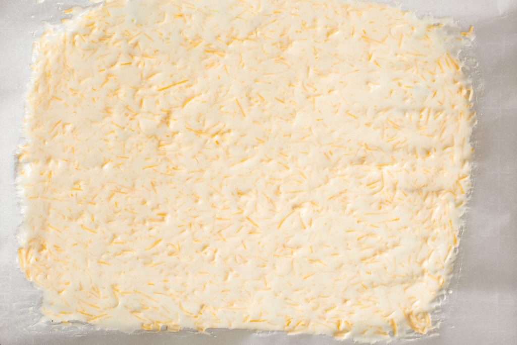 batter for sourdough discard crackers spread very thinly on a baking sheet