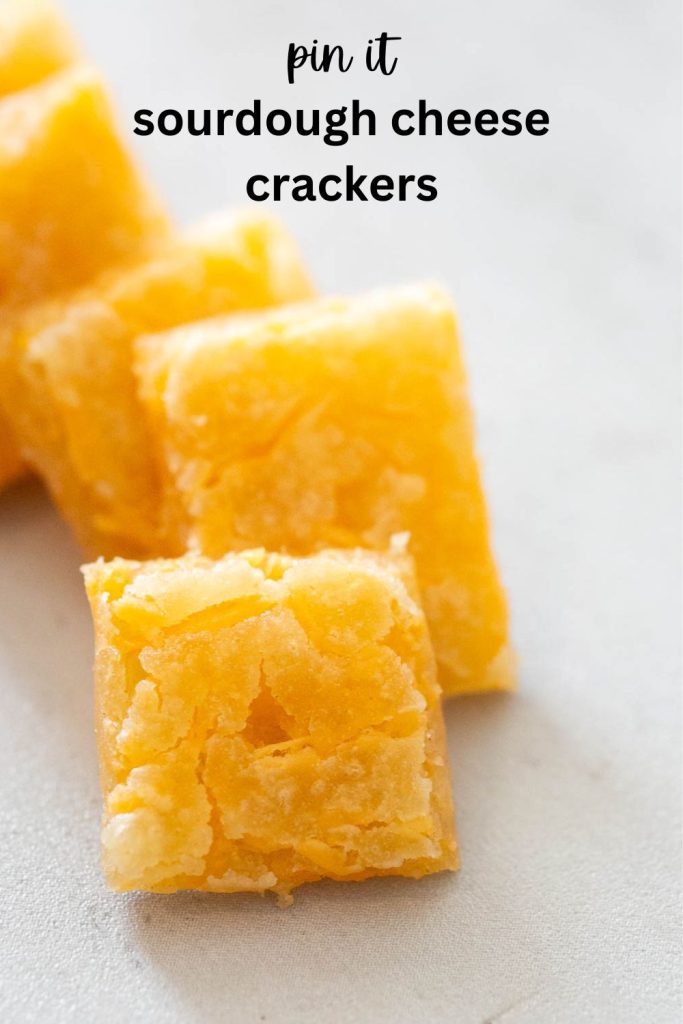 a pinterest pin featuring a stack of sourdough discard cheese crackers