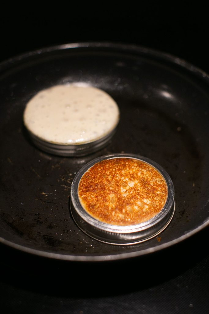 sourdough pikelets cooking in a pan