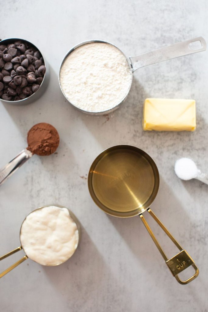 ingredients for sourdough chocolate croissant bread:  frozen butter, chocolate chips, sourdough starter, flour, cocoa powder and salt