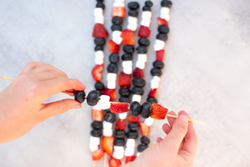 fruit skewers with strawberries, marshmallows and blueberries. 