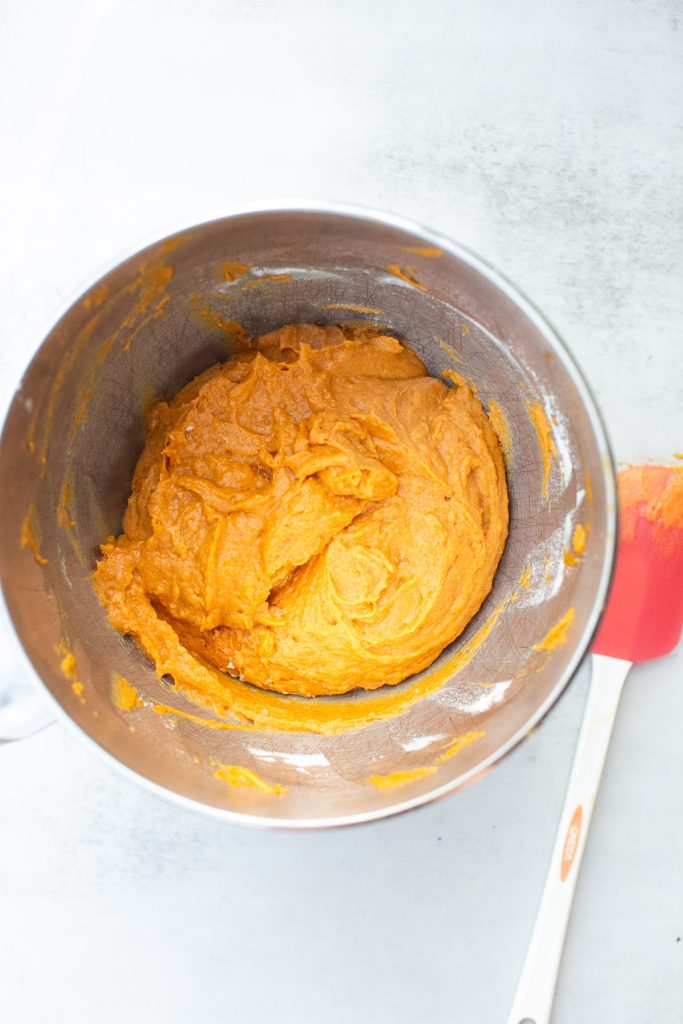 wet ingredients for pumpkin muffins mixed in a stand mixer