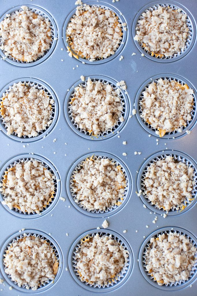 streusel topping on top of pumpkin muffins