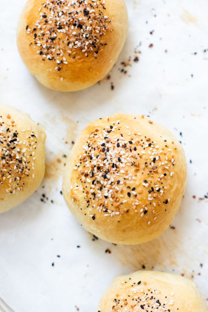 sourdough discard hamburger buns on a baking sheet