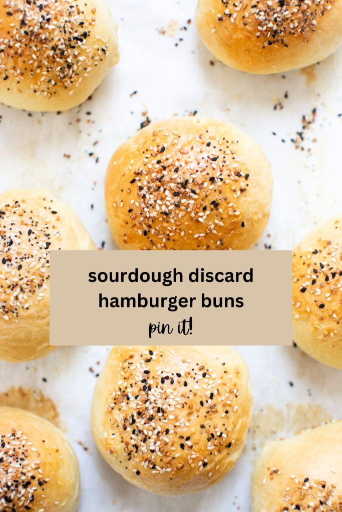 a pinterest pin with a photo of sourdough discard hamburger buns on a baking sheets