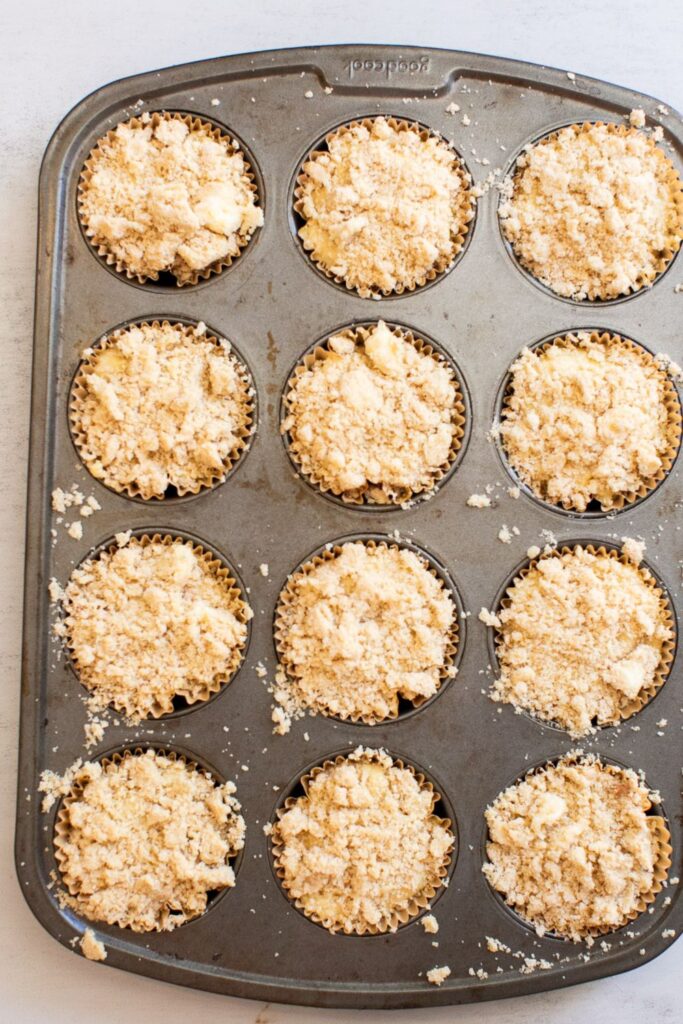 caramel apple muffins with crumb topping sprinkled on top