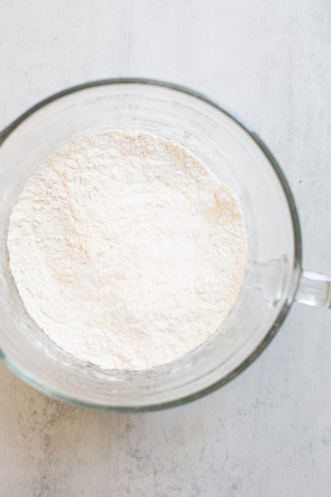 dry ingredients for apple crumble muffins in a bowl:  all purpose flour, salt, baking soda, baking powder, cinnamon