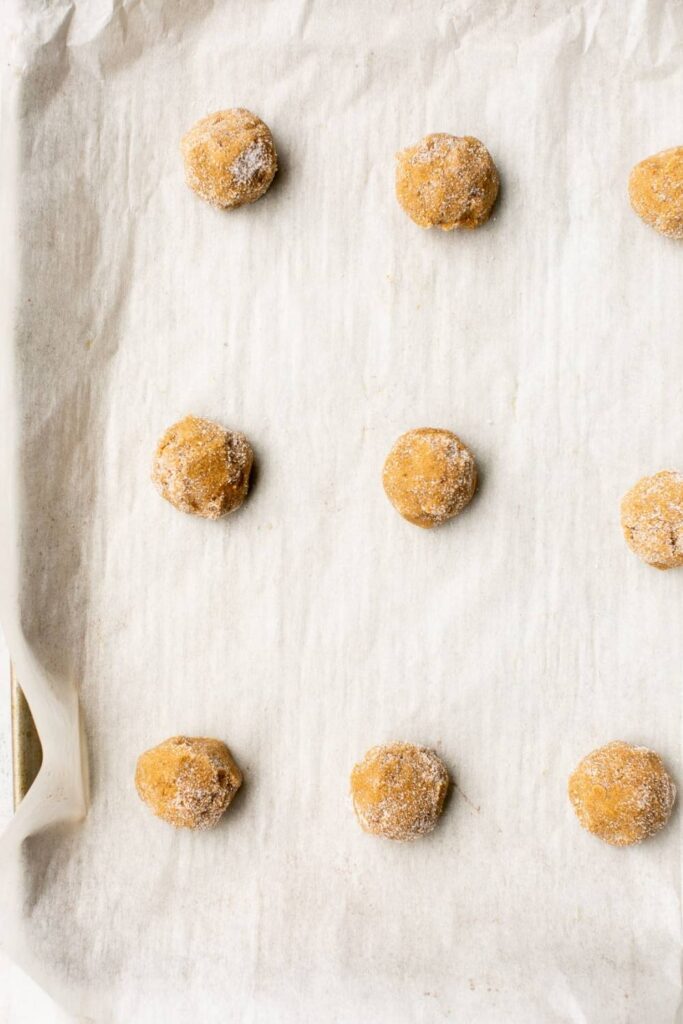 sourdough gingersnap cookie balls on a baking tray