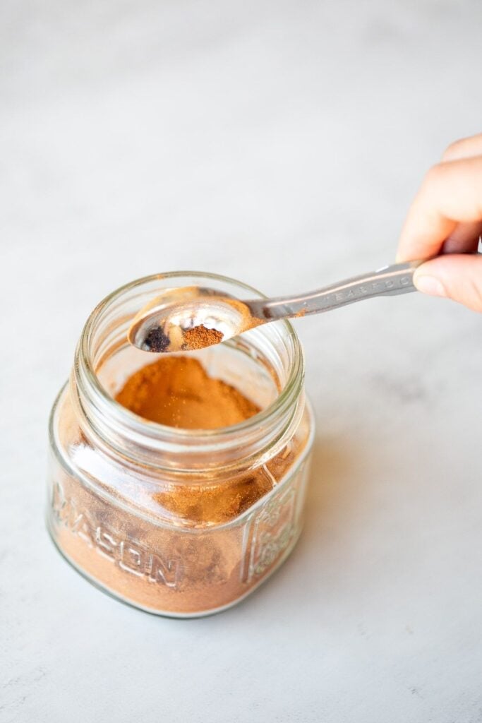 Homemade pumpkin pie spice in a glass jar.