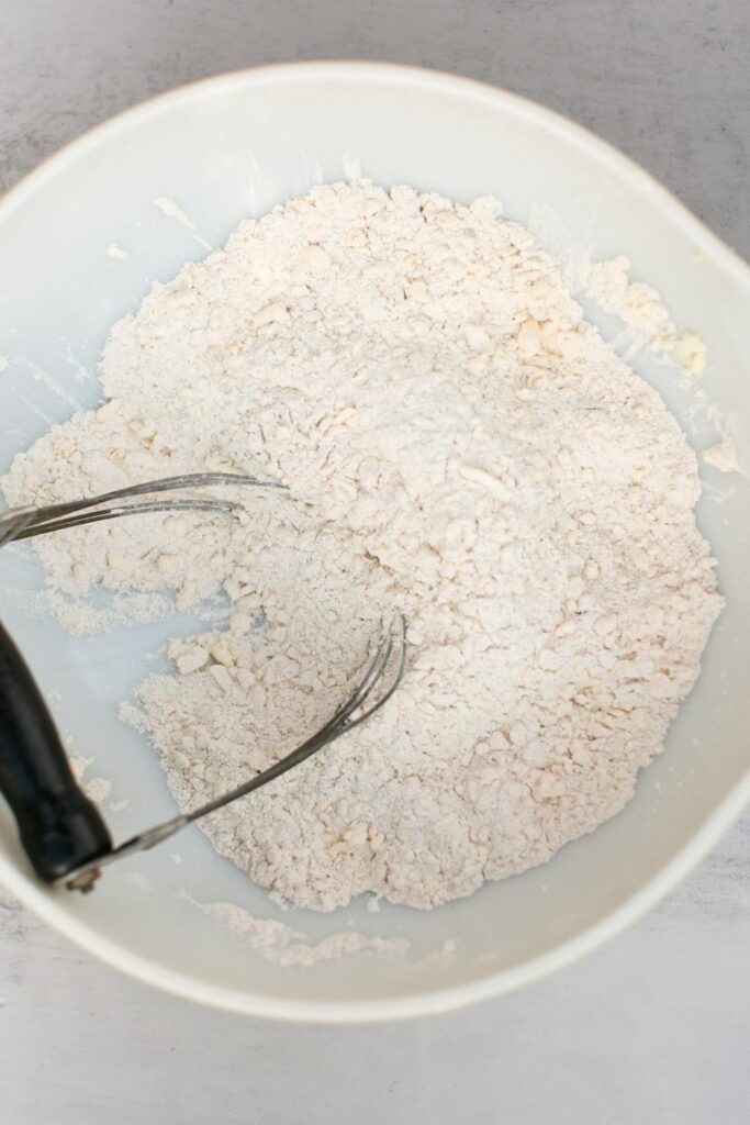 flour mixed with frozen butter for scones