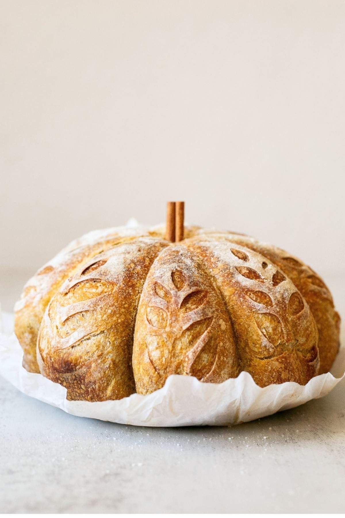 A sourdough bread loaf in the shape of a pmpkin.
