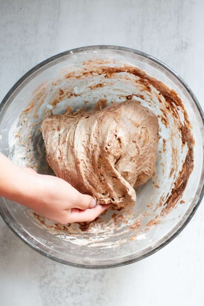 sourdough chocolate focaccia dough being stretched and folded over itself