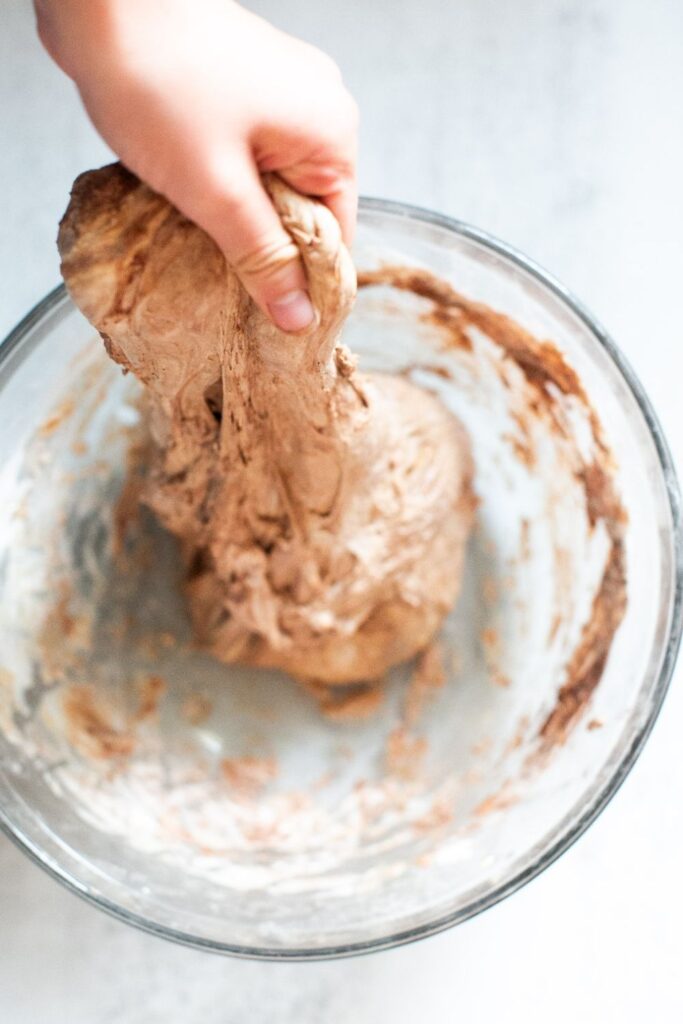 sourdough chocolate focaccia dough being stretched and folded over itself