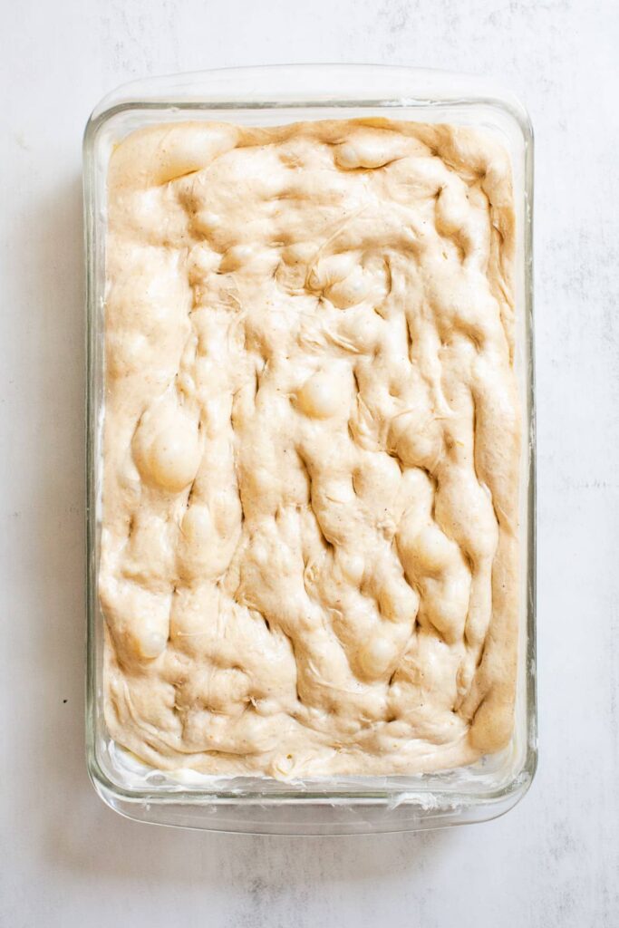 sourdough pumpkin spice focaccia bread after it has been dimpled