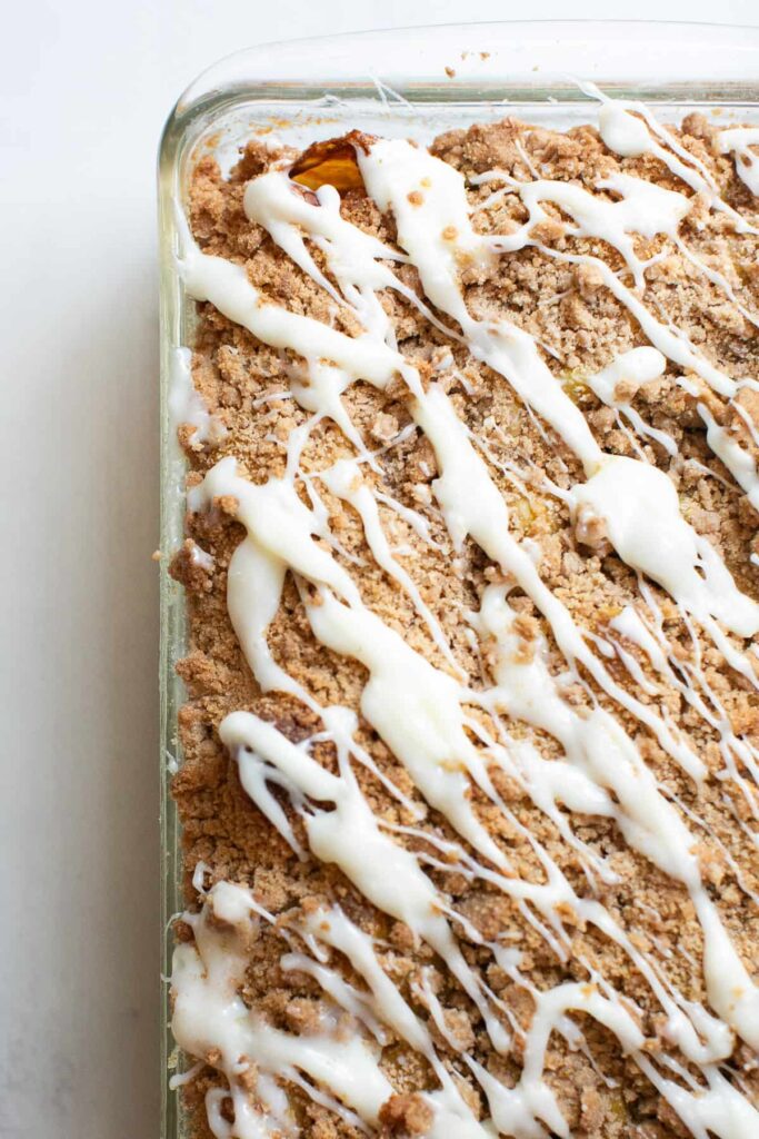 sourdough pumpkin spice focaccia bread with cream cheese frosting drizzled on top