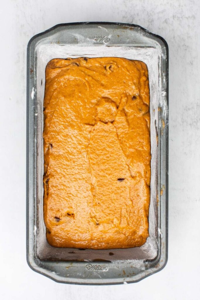 batter for sourdough discard pumpkin bread with chocolate chips in a 9x5 pan