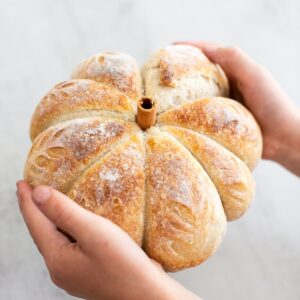 pumpkin shaped sourdough bread loaf with a cinnamon stick stem