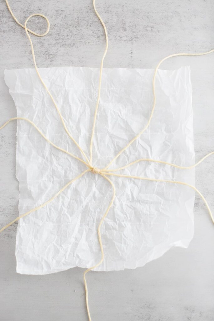 baker's twine spread out over a piece of parchment paper