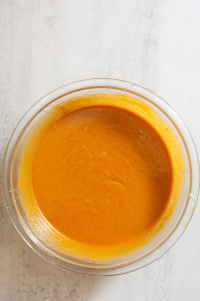wet ingredients in a medium bowl for sourdough discard pumpkin bread