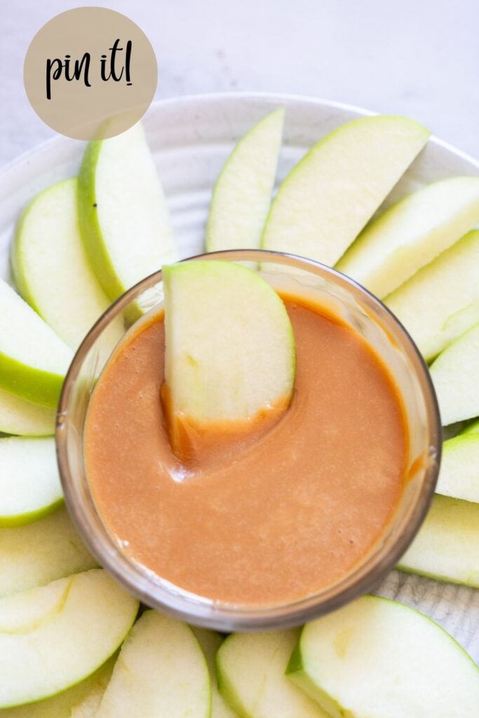 3 ingredient homemade caramel apple dip in a bowl with apples around it
