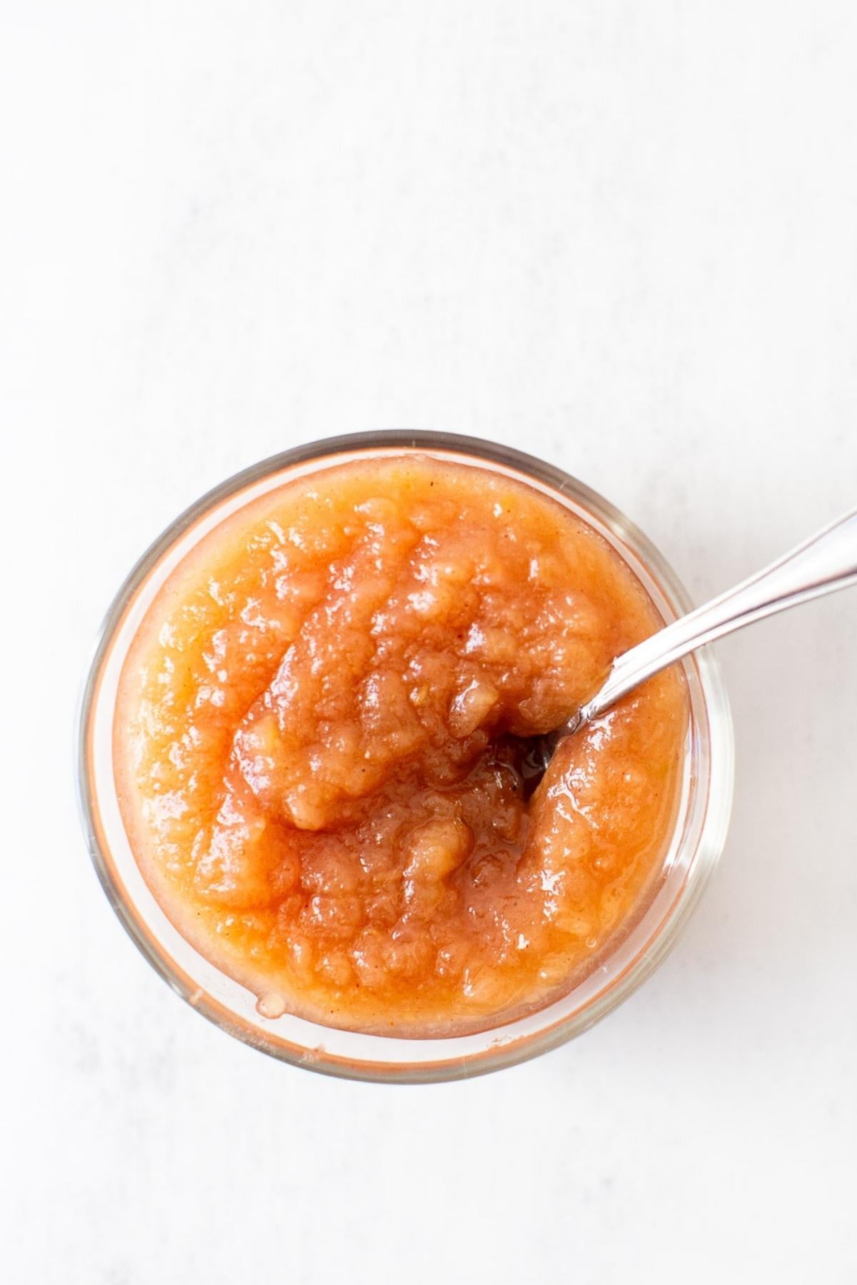 homemade applesauce in a small dish on a counter.