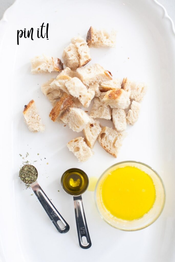 ingredients for sourdough croutons: butter, italian seasoning, bread chunks and oil