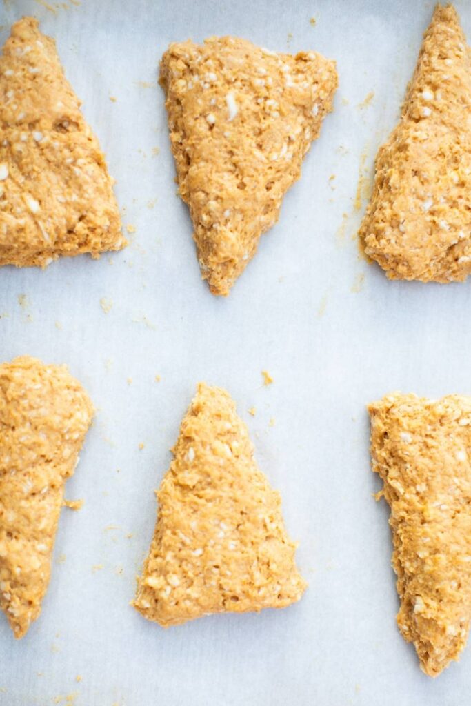 pumpkin scones with maple glaze dough cut into wedges