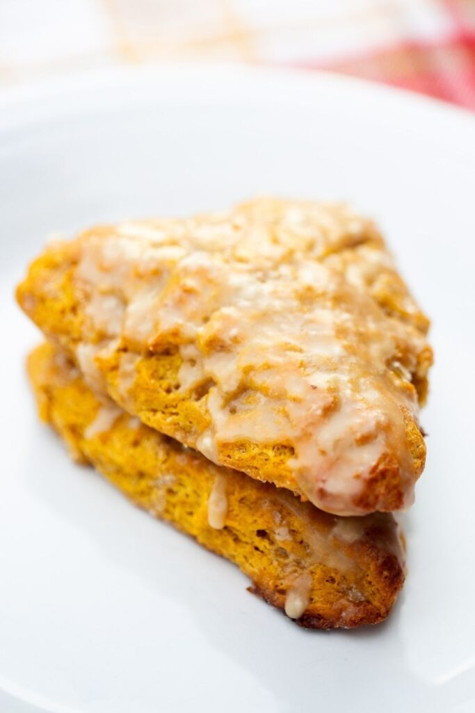 easy pumpkin scones made with maple glaze on a plate