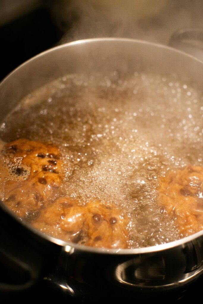 sourdough chocolate chip bagels boiling in a pot