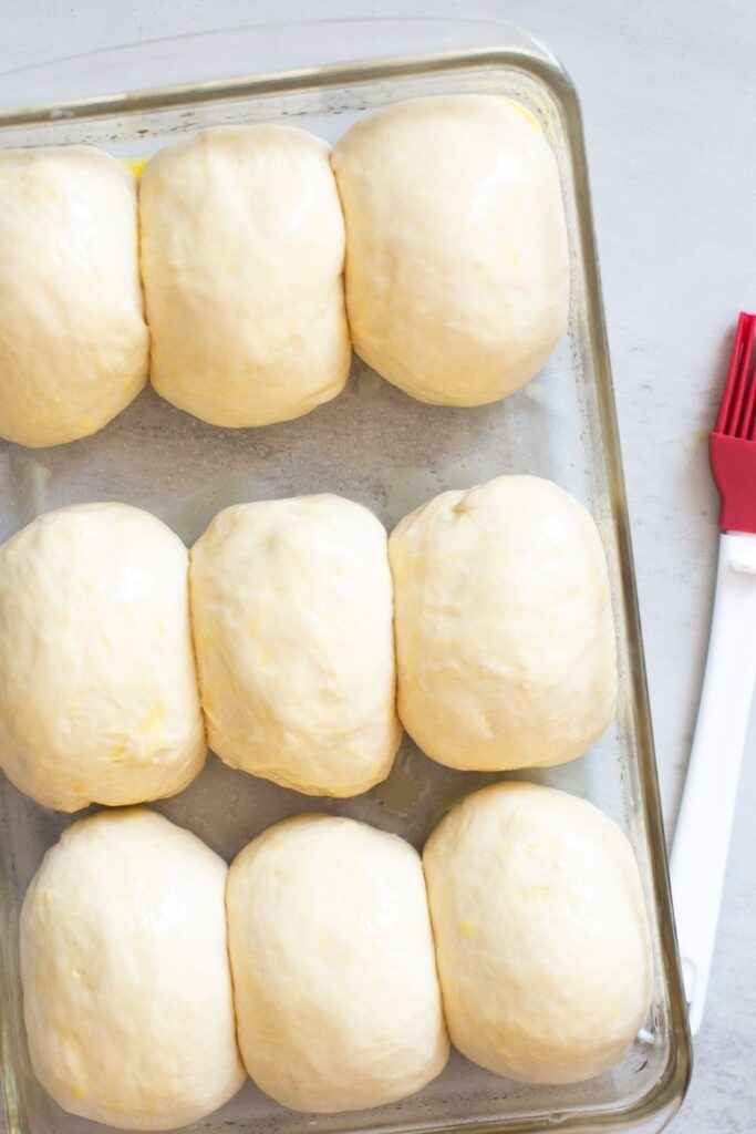 sourdough discard rolls lined up in a pan 