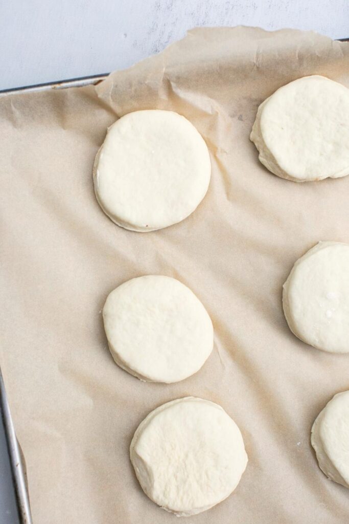 sourdough English muffins on a pan