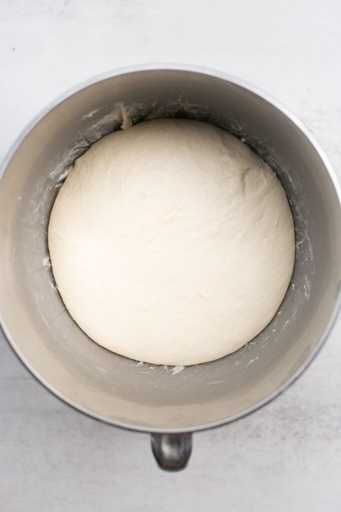 sourdough english muffin dough in a large mixing bowl