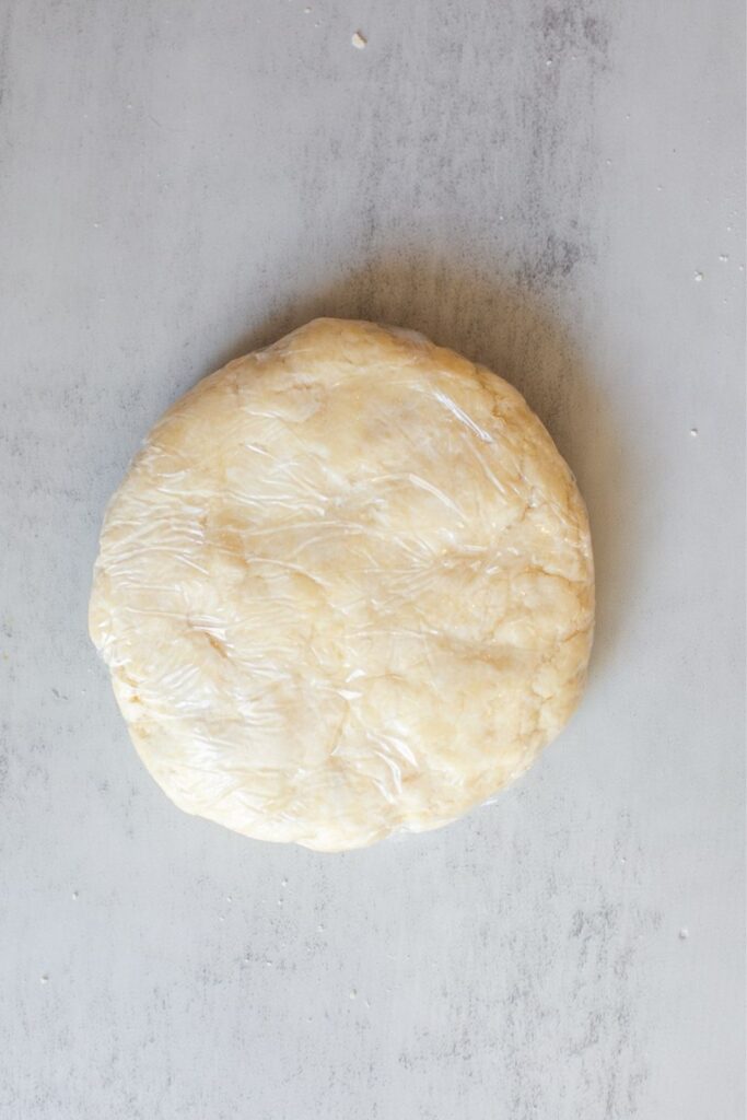 sourdough discard pie dough wrapped in plastic wrap