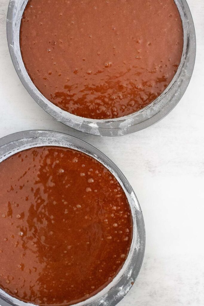 chocolate espresso cake batter poured into cake pans