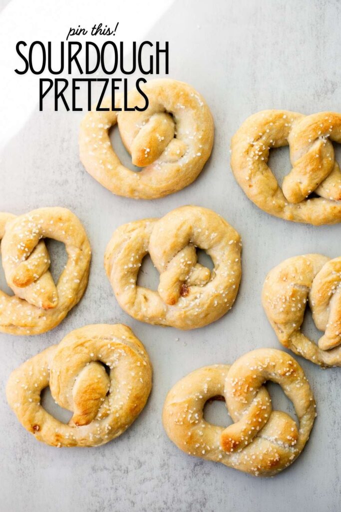 a pinterest pin with a photo of homemade sourdough pretzels on it