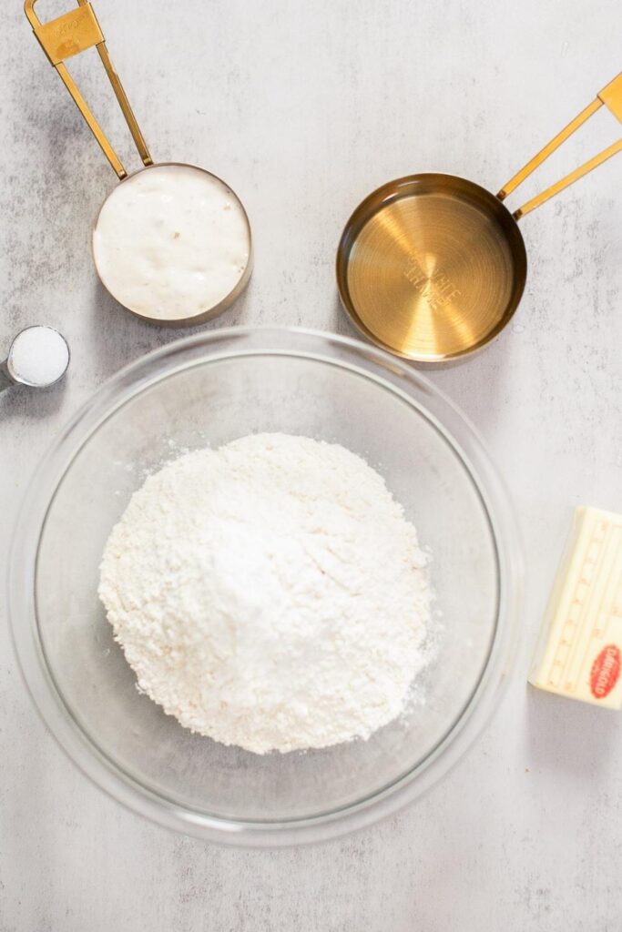 ingredients for sourdough croissant bread dinner rolls: butter, flour, salt and active sourdough starter